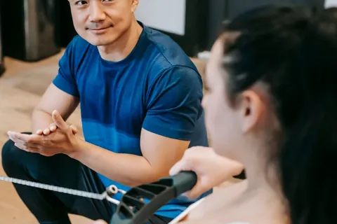 Coach supporting a client during a workout