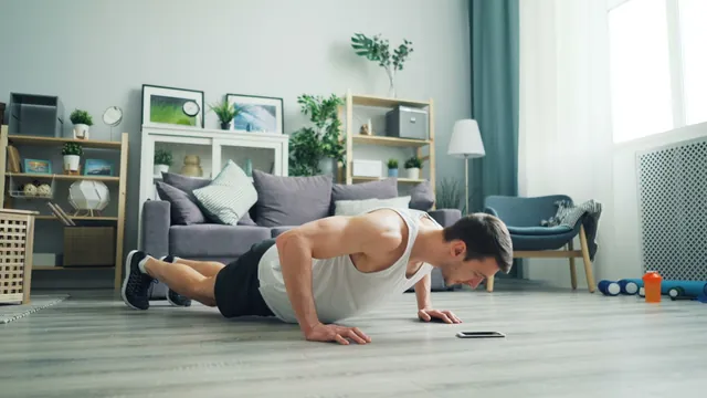 Man doing push-ups at home in a living room