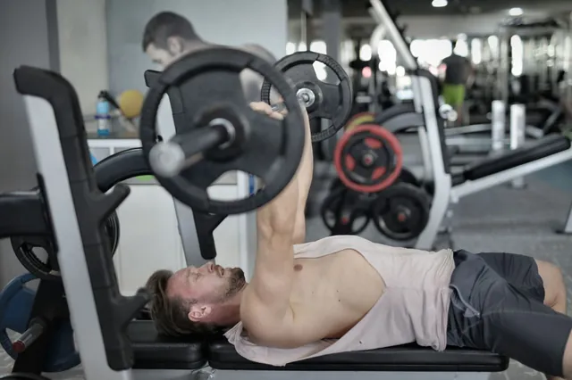 Lifter pressing a barbell on a bench
